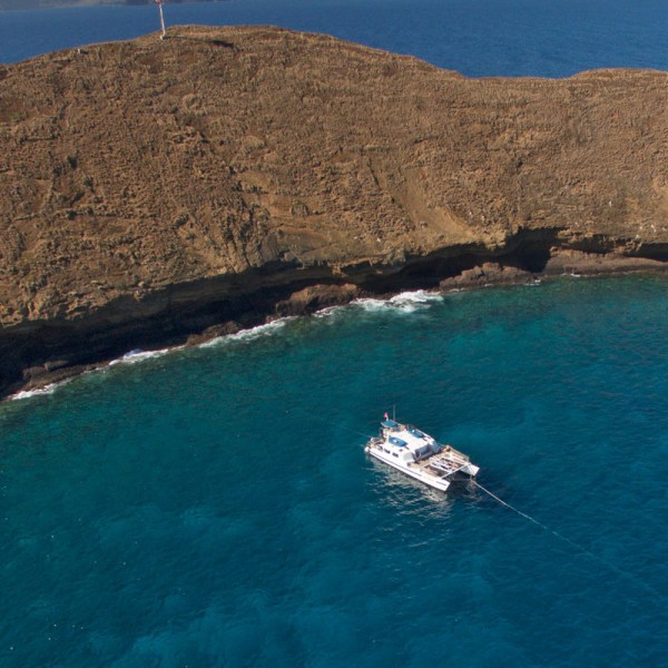 a body of water with a mountain in the background