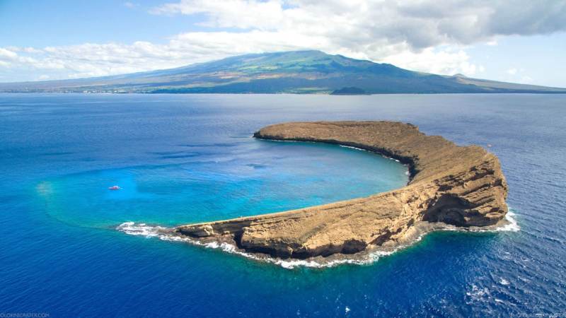 a body of water with a mountain in the background
