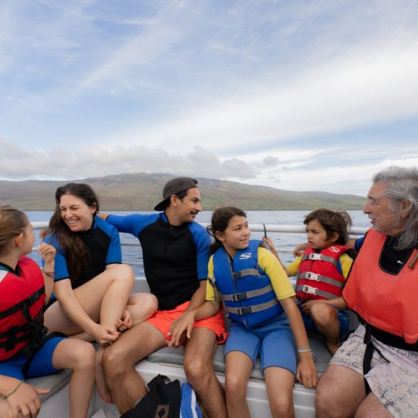 a group of people sitting next to a body of water Malolo Molokini Snorkeling on Maui