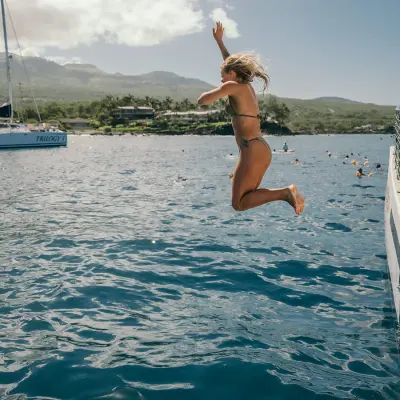 a person riding on the back of a boat in a body of water