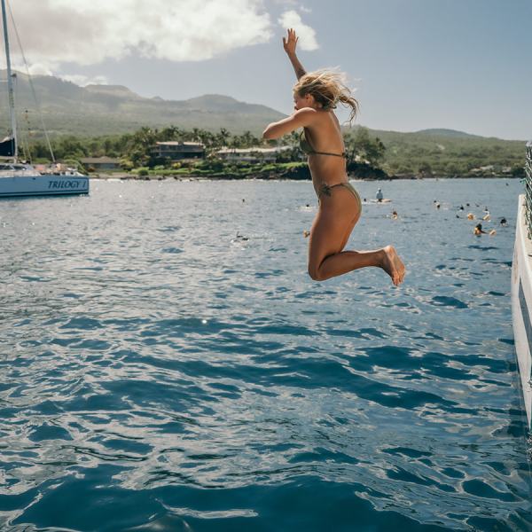 a person riding on the back of a boat in a body of water
