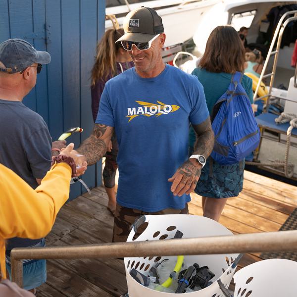 a group of people standing on a boat