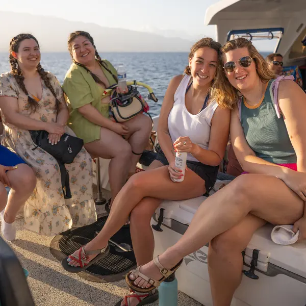 a group of people sitting at a beach