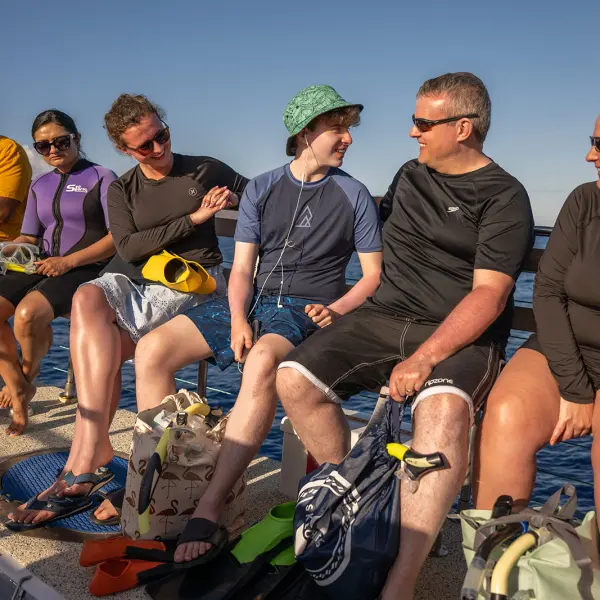 a group of people sitting on a bench