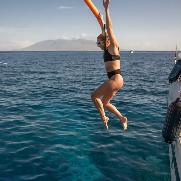 a person standing next to a body of water