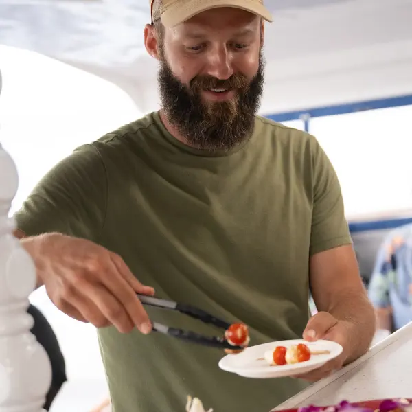 a man sitting at a table with a plate of food