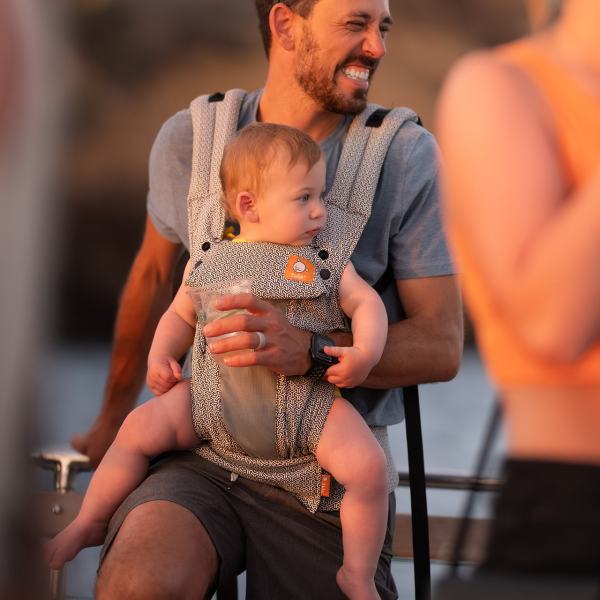 a man sitting in a chair talking on a cell phone